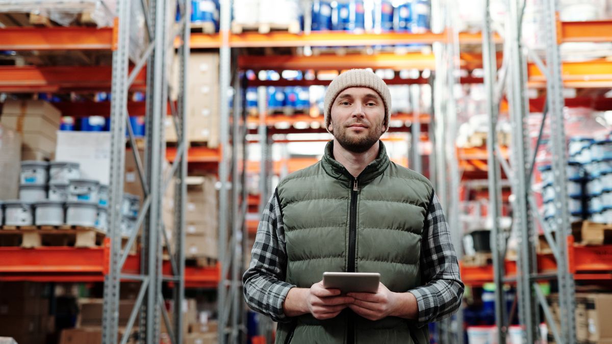 A worker holding a tablet